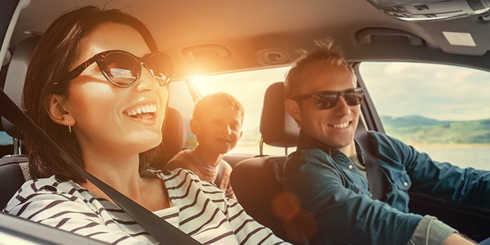 Happy family enjoying the road in their vehicle